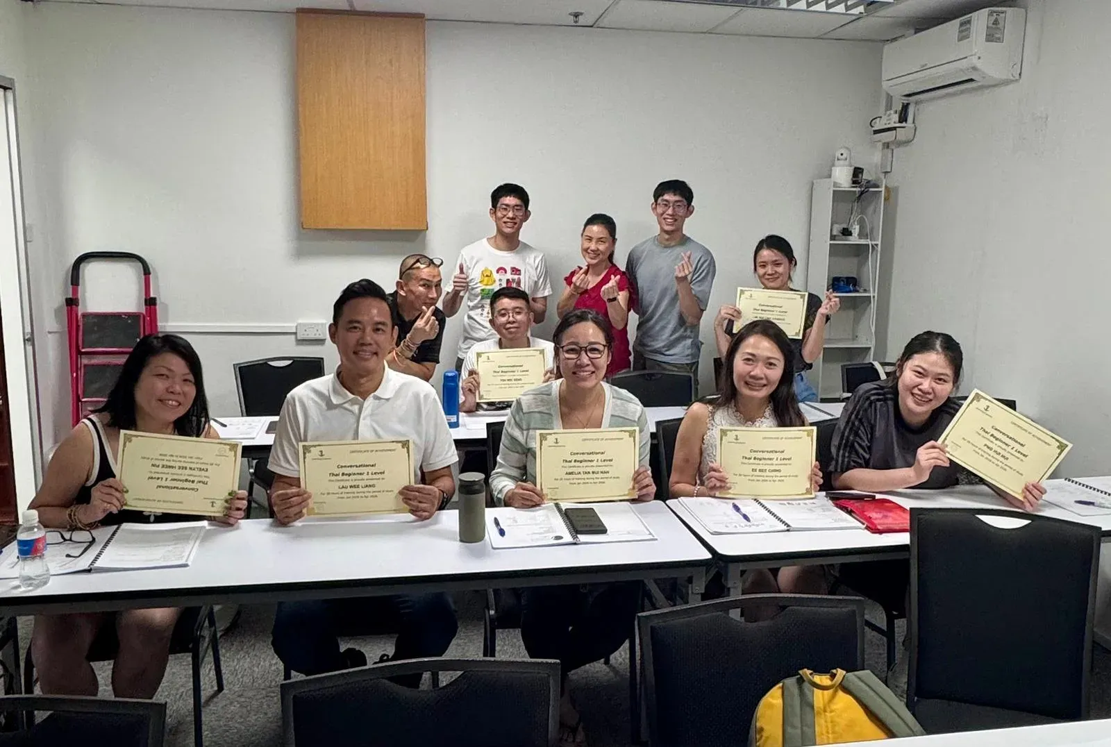 A Thai class celebrating the end of their course with their teacher