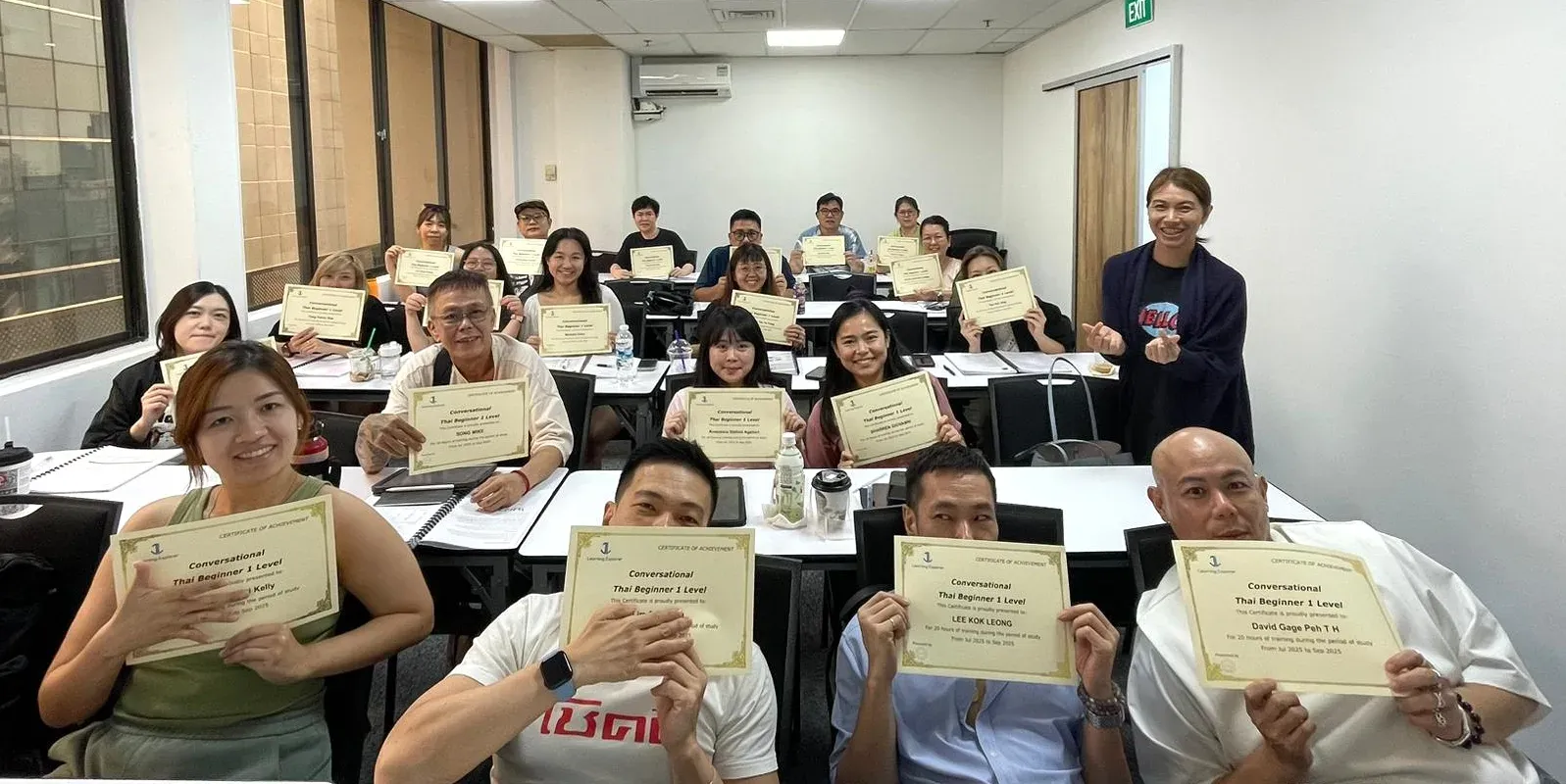 A Thai Explorer class holding their Conversational Thai Beginner certificates