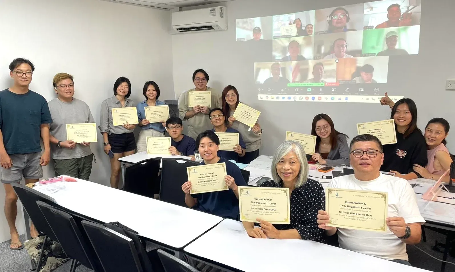 Classroom and online students graduating together