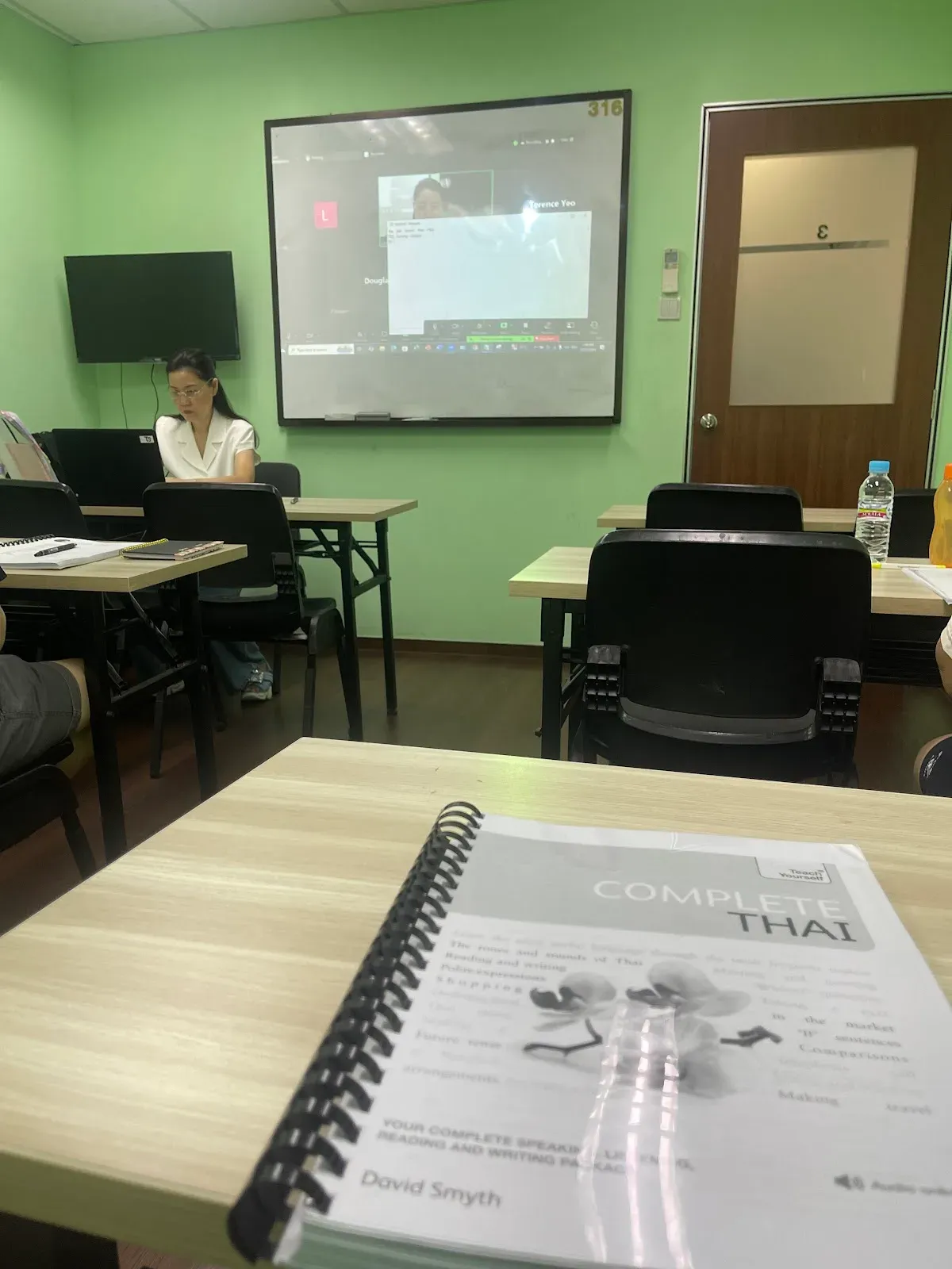 The Complete Thai course book on a classroom desk